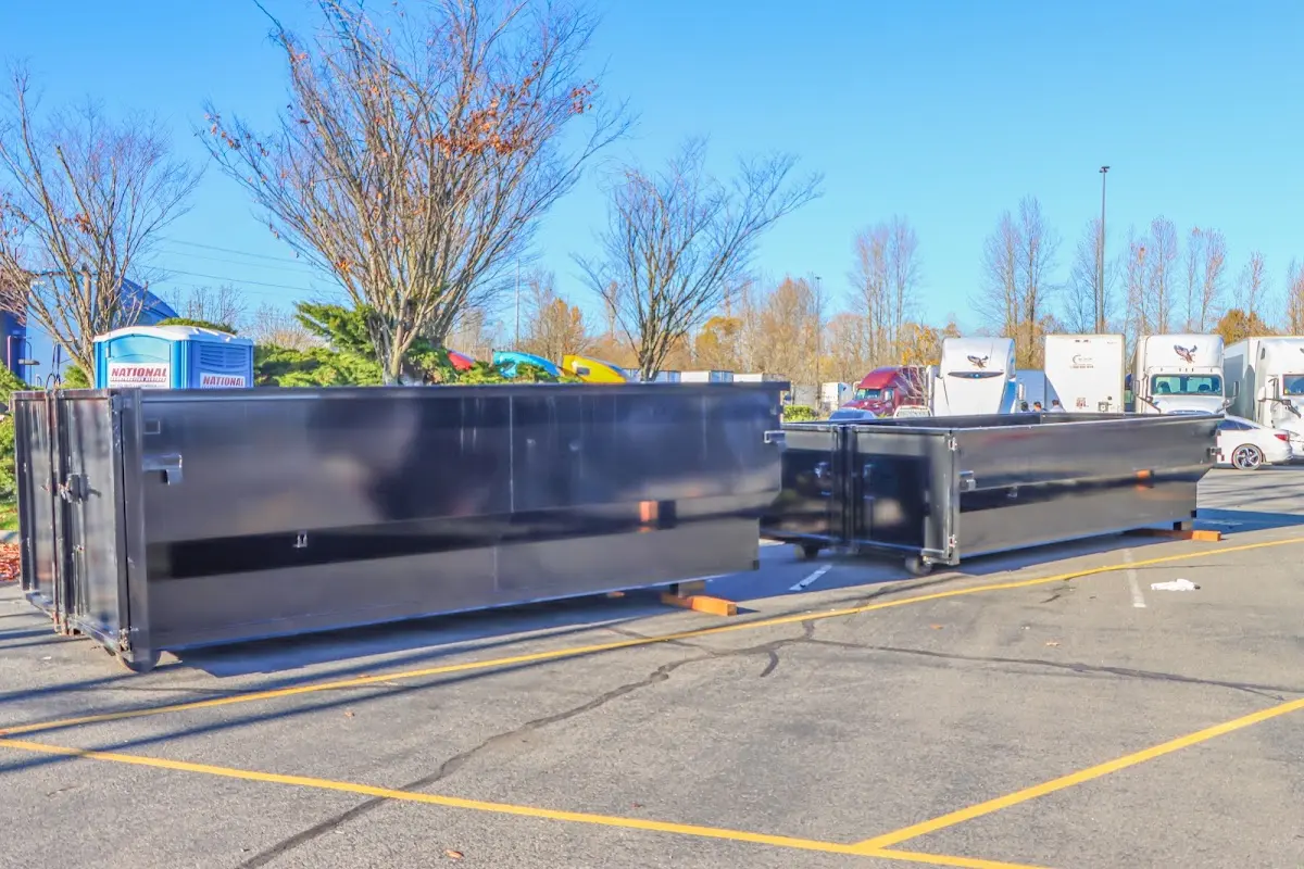 Professional dumpster rental service with roll-off container on residential driveway in Fort Pierce